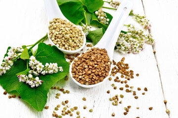 Buckwheat brown and green in spoons on white board