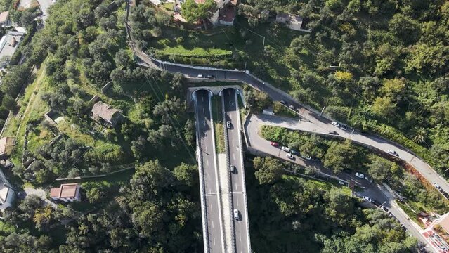 Aerial view of vehicles driving on the highway entering the tunnel in Salerno, Campania, Italy.