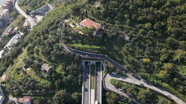 Aerial view of vehicles driving on the highway entering the tunnel in Salerno, Campania, Italy.