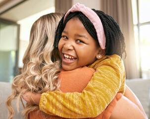 Hug, mother and adopted black girl in living room of house, foster home or orphanage in support,...
