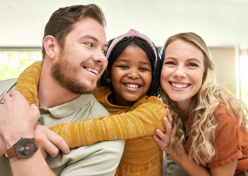 Family, adoption and parents hug child, love and happiness with child care portrait, relax at family home. Happy, bonding and interracial people with foster care and mother, father with kid.