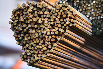 Thin metal rods stack on large rack in cold plant warehouse
