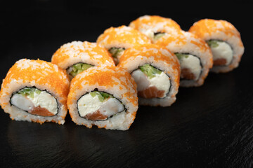 Philadelphia, California sushi. sushi rolls with shrimp and salmon on black background. Shrimp sushi rolls.