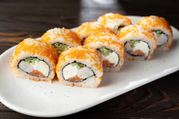 traditional fresh japanese sushi rolls on a white plate.