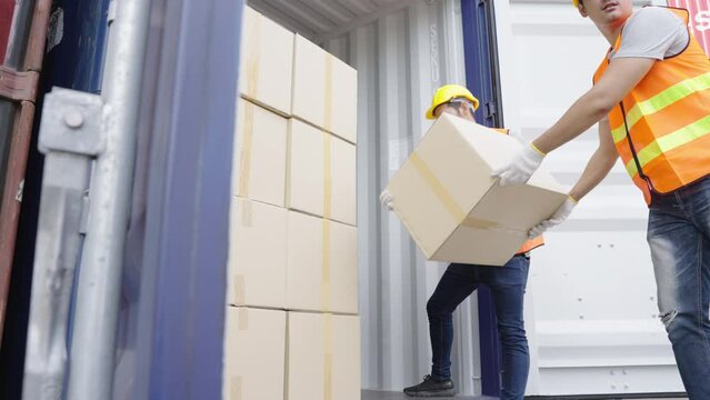Men worker loading cardboard boxes into containers, Warehousing and logistic shipping cargo concept