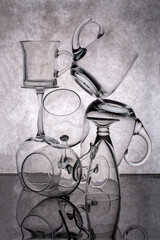 Still life with empty glass goblets on a gray background