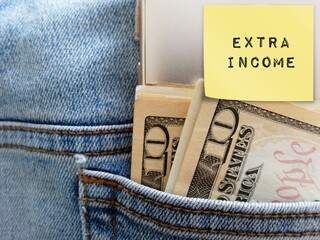 Pen and cash dollar money in jeans pocket with text written note Extra Income,  concept of make...