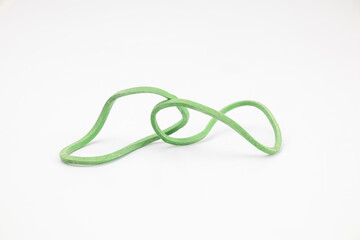 Two green rubber bands in abstract shapes on a white background.