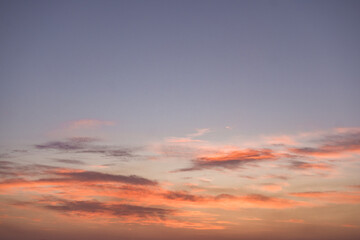 Real amazing panoramic sunrise or sunset sky with gentle colorful clouds. Long panorama, crop it. Colorful cloudy sky at sunset. Gradient color. Sky texture, abstract nature background