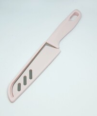 This is an isolated photo of a knife that has a pink handle.