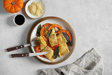 Homemade Pumpkin Ravioli with ricotta cheese served sage butter , cheese, pieces of pumpkin and...