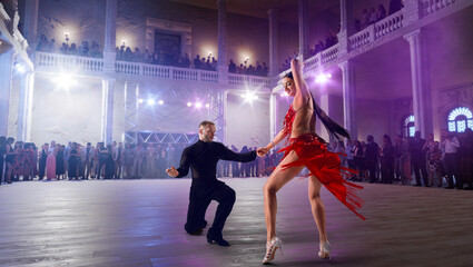 Couple dancers perform latin dance on large professional stage. Ballroom dancing.
