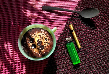 cup of coffee, match, cigarette  with spoon