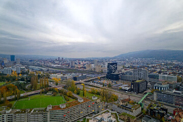 Aerial view over City of Zürich with cloudy sky and local mountain Uetliberg in the background on a cloudy autumn day. Photo taken November 12th, 2022, Zurich, Switzerland.