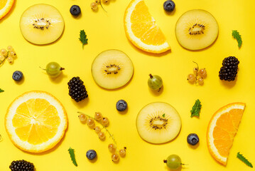 Fototapeta na wymiar fruits and berries on the yellow background