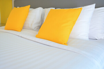 yellow pillow on white bed, interior design