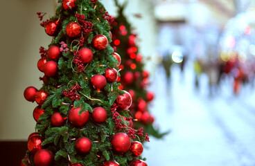 Christmas green tree with red balls Decorations on the street with blurred background with bokeh