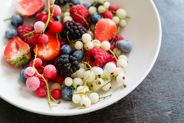 Obraz na płótnie Canvas frozen berries on white plate