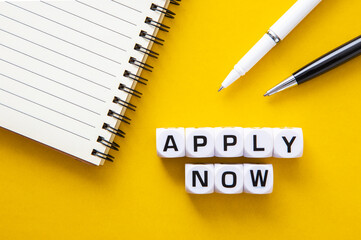  Business concept. Notepad and pen with the text APPLY NOW