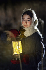 A girl at night in the snow goes in search of a miracle with a lantern.