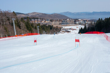 Marked and fenced snow-covered ski track for competition on the mountain in winter