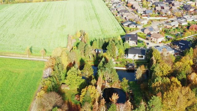 Detached house on the outskirts of a suburb in Germany, which includes a plot with small ponds for fish farming
