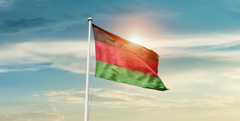 Malawi national flag cloth fabric waving on the sky - Image