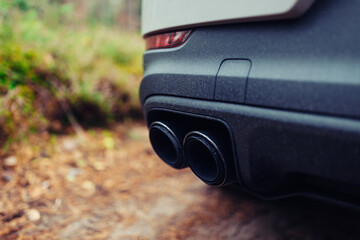 Modern and luxury sports car exhaust system pipes at the forest