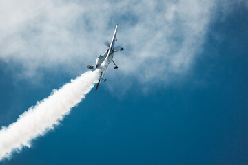 Airplane make smoke trails and loop