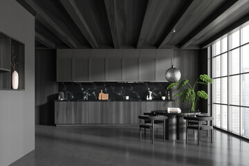 Grey kitchen interior with eating table and seats, panoramic window