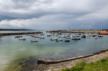 Fototapeta na wymiar View of Portrush harbour with small boats 