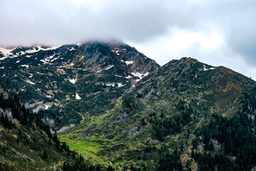 Fototapeta premium View on the Couserans and the French Pyrenees mountains range on a cloudy day near Ayes lake