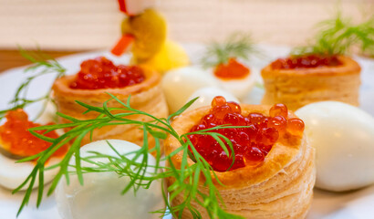 Closeup of caviar and cream cheese appetizer on crackers