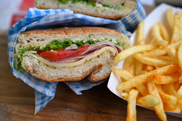 Italian ciabatta bread sandwich with rucola , tomatoes and  prosciutto  crudo
