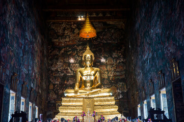 Obraz premium Golden Buddha Statue in Wat Suthat Thepwararam, is a royal Buddhism temple of the first grade, one of ten such temples in Bangkok and located in the combretum grove