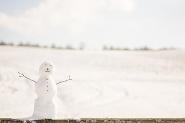 snowman at snowy bokeh background