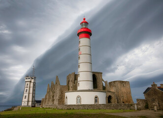 Dramatic stormy clouds over Lighthouse Pointe de Saint-Mathieu, Brittany (Bretagne), France