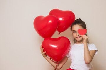 teen girl holding heart shaped balloons