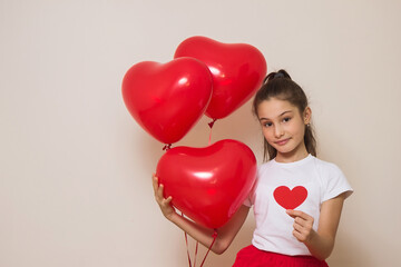 Fototapeta na wymiar teen girl holding heart shaped balloons