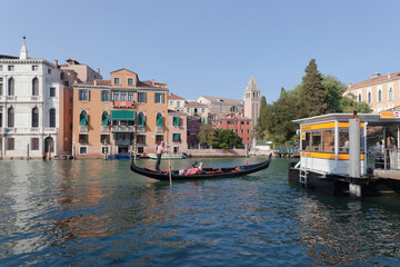Fototapeta na wymiar Venezia. Canal Grande con gondoliere e stazione del vaporetto