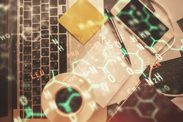 Physics and math theme hologram with formula drawings over computer on the desktop background. Top view. Multi exposure. Concept of education.