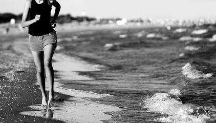 girl jogging running on the seashore with black and white effect