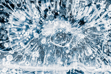 Ice texture background. Textured cold frosty surface of an ice block with frozen air bubbles on...