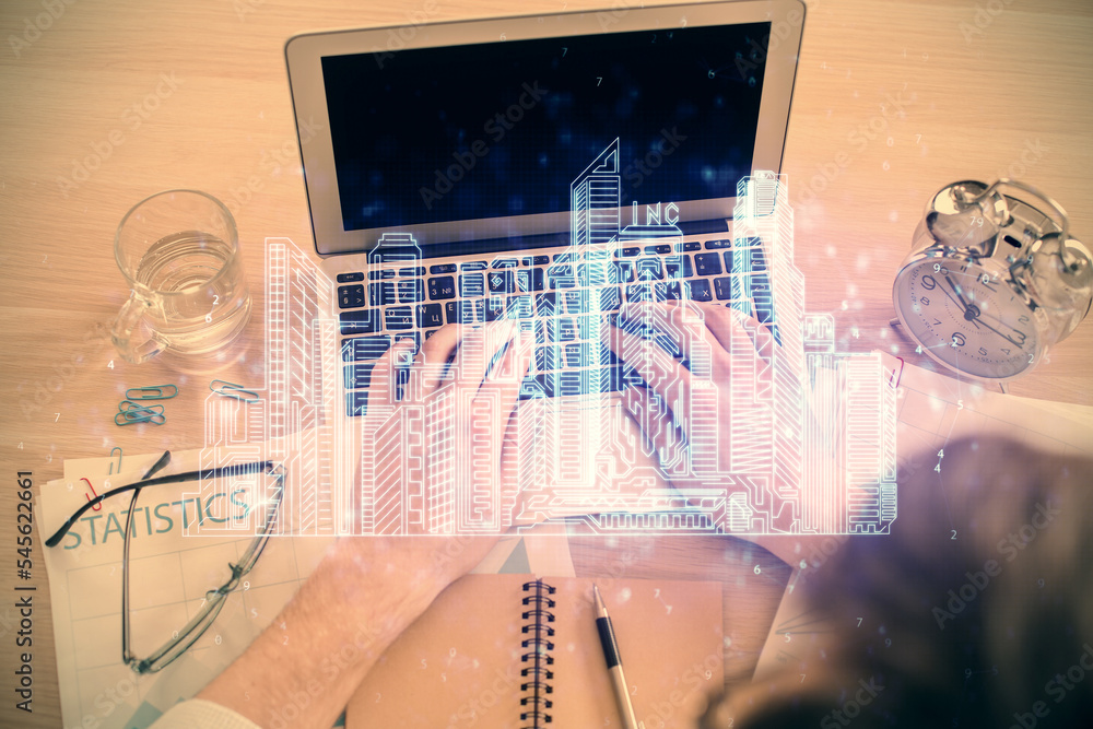 Aufkleber Double exposure of man's hands typing over computer keyboard and buildings drawing. Top view. smart city concept.