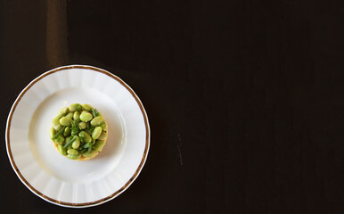 Soy Beans And Polenta On A Plate, Round Shape, Dark Brown Background, Off Centre, Negative Space