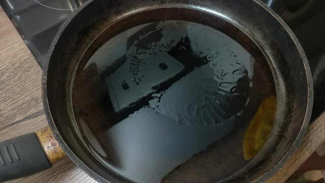 The cook is frying pancakes in a frying pan