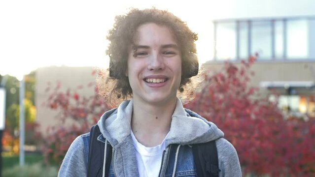 Portrait of a cheerful teenager in headphones.