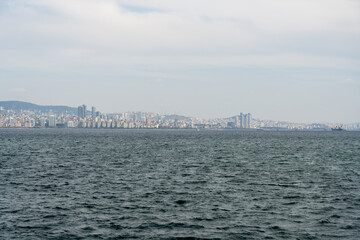Fototapeta na wymiar Istanbul, Turkey. 11 12 2022. View of the city and buildings of the Anatolian side of Istanbul from the sea.