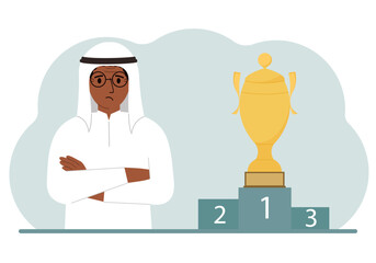 A muslim man next to the pedestal on which the cup for victory and first place.