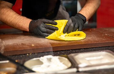 process of preparing traditional Turkish fast food - grilled meat or shawarma or kebab. chef hand cooking food
